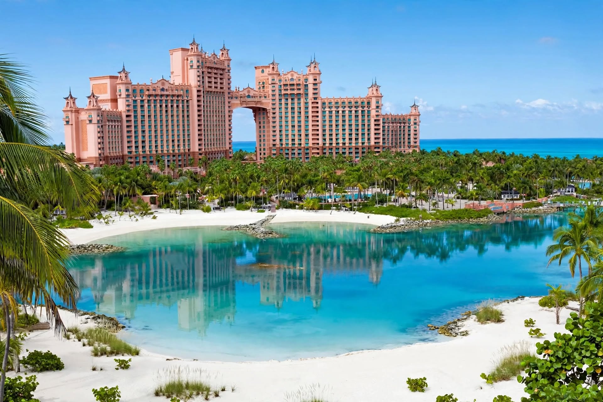 Atlantis Paradise Island Royal Towers flanked by turquoise ocean water and palm lagoons